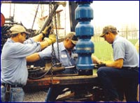 Three men drilling
