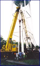 A crane lifting a pipe